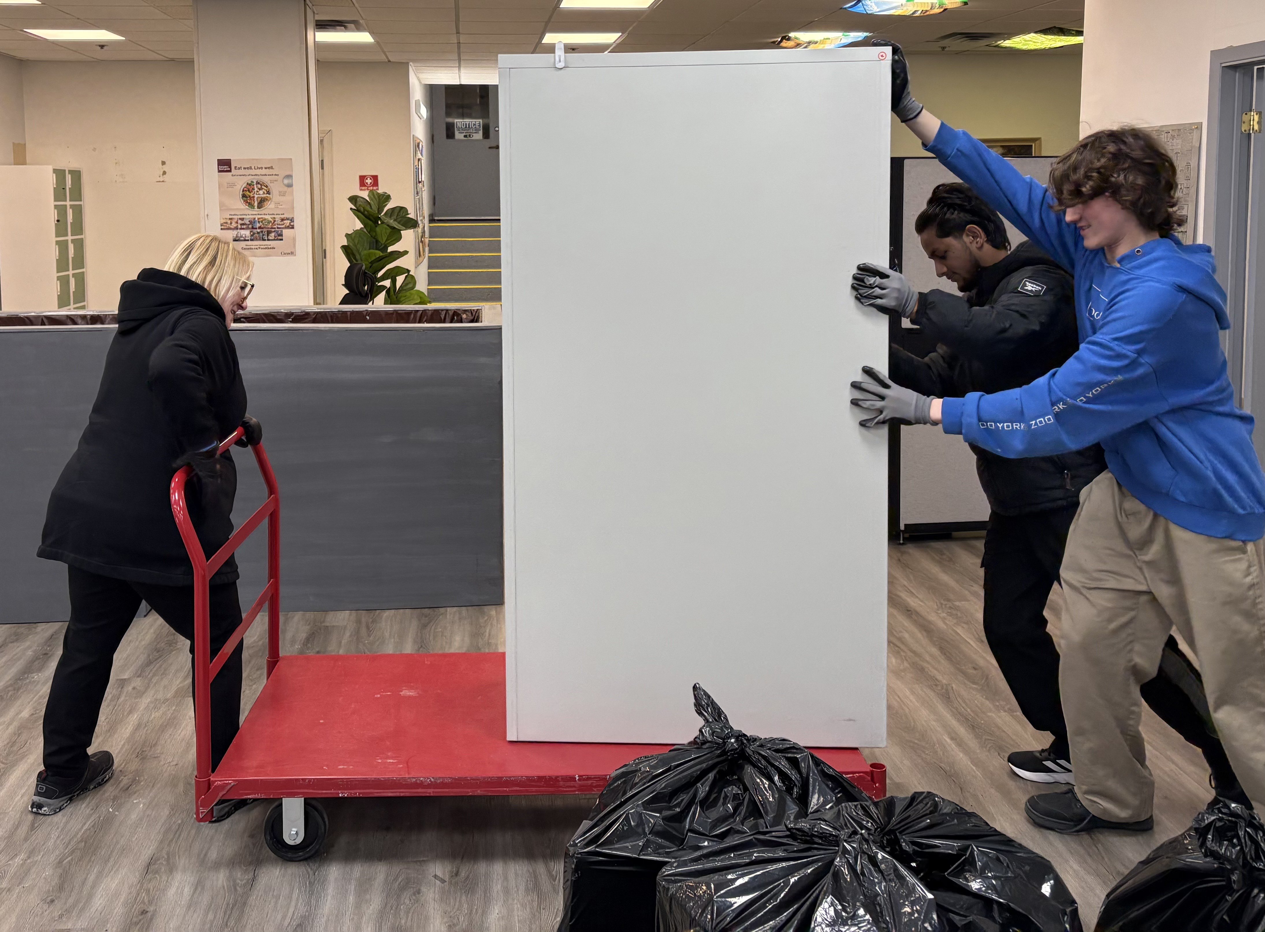volunteers pushing wheeled cart